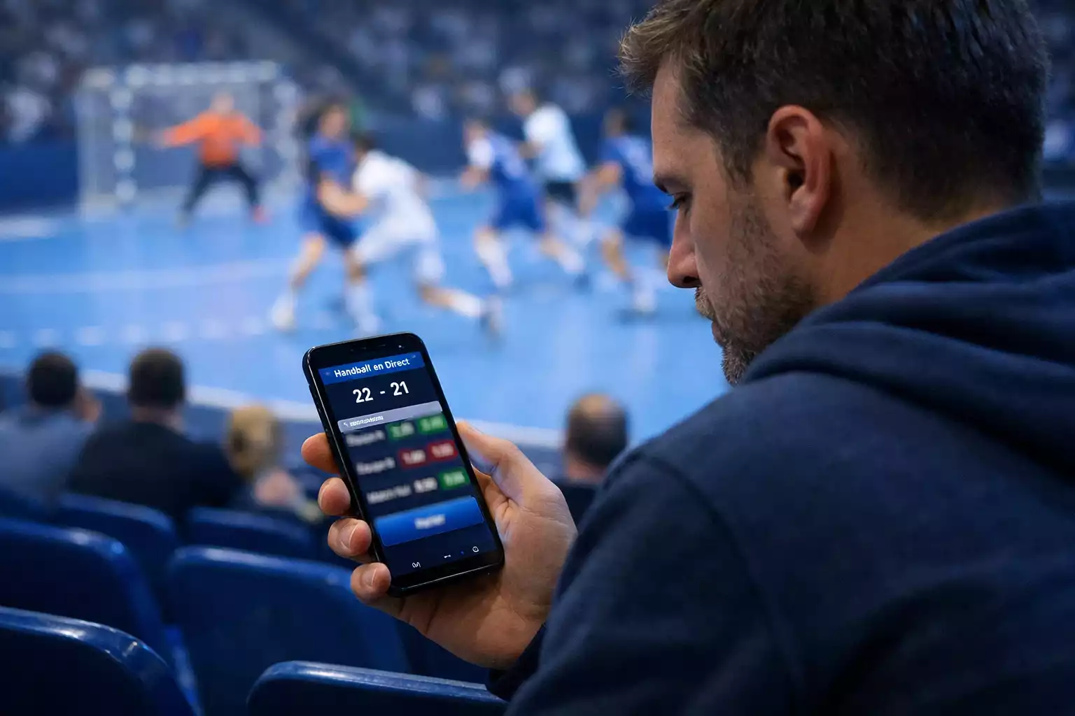 Spectateur regardant un match de handball en direct sur smartphone